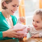 16193906 – mother and daughter with piggy bank